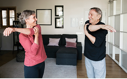 A couple exercising in their living room